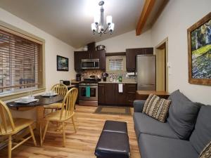 a kitchen and living room with a couch and a table at Hot tub Oasis Among Trees - Pet Friendly in Port Renfrew