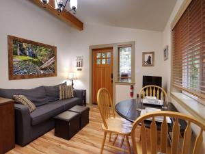 a living room with a couch and a table at Hot tub Oasis Among Trees - Pet Friendly in Port Renfrew +19 photos