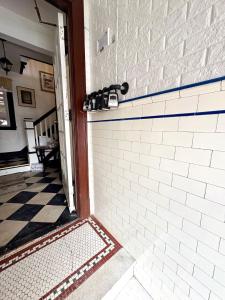aoyer with a white brick wall and a tile floor at The Bushnell Suite C2 in Hartford +18 photos