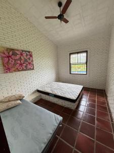 a room with two beds and a ceiling fan at Casa 2 Silvia Beatriz in Holambra +14 photos