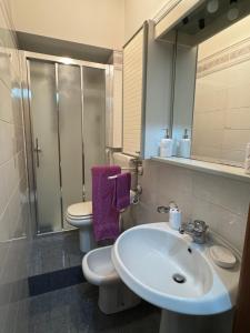 a bathroom with a sink and a toilet and a mirror at Il Gelso Bianco in Bordighera