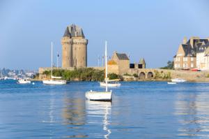 a group of boats in the water in front of a castle at Le Bristol in Dinard +28 photos