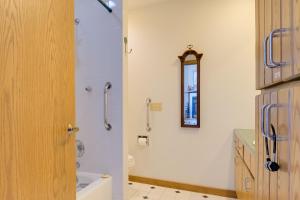 a bathroom with a shower and a toilet and a sink at Lake Access w/ Dock! Hayward Cabin Hideaway in Hayward +16 photos