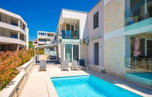 a house with a swimming pool next to a building at Apartments M&L in Vodice