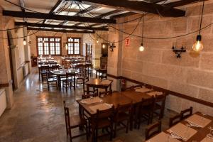 a restaurant with tables and chairs in a room at Casa Palomin in Ourense