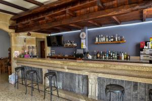 a bar with stools in a room at Casa Palomin in Ourense +4 photos