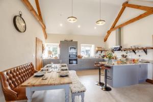a dining room with a table and a kitchen at 3 Bed in Llanrwst oc-bow155 in Llanrwst