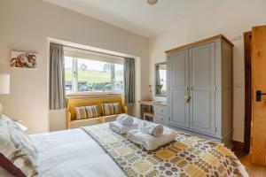 a bedroom with a large bed with towels on it at 3 Bed in Llanrwst oc-bow155 in Llanrwst