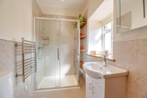 a bathroom with a shower and a sink at 3 Bed in Llanrwst oc-bow155 in Llanrwst +24 photos