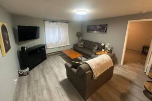 a living room with a couch and a television at Homestake Haven in Lead