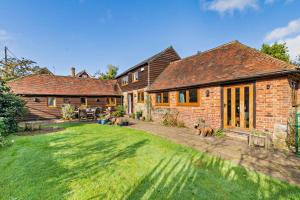 a house with a yard with two dogs in front of it at 4 Bed in Flimwell oc-g30190 in Ticehurst
