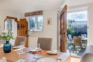 a dining room with a table and chairs and a dining room at 4 Bed in Flimwell oc-g30190 in Ticehurst