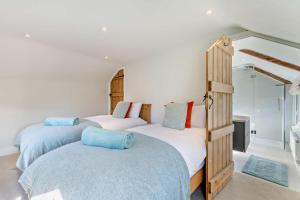 a bedroom with two beds and a mirror at 4 Bed in Flimwell oc-g30190 in Ticehurst