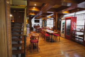 a restaurant with tables and chairs and a coke machine at Comodoro Hotel in Comodoro Rivadavia