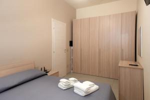 a bedroom with a bed with towels on it at ASARO Camere in Campobello di Licata
