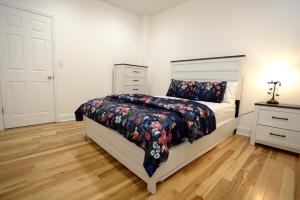 a bedroom with a bed and a dresser at Spacious and Brand New Apartment in Point Breeze - Prime Location in Philadelphia