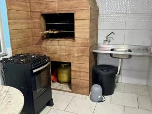 a small kitchen with a stove and a sink at Sol e Mar BC in Balneário Camboriú +73 photos