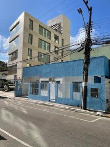 a blue building on the side of a street at Sol e Mar BC in Balneário Camboriú