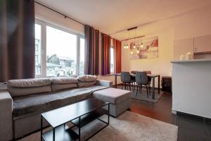a living room with a couch and a table at Appartement Wim in Blankenberge
