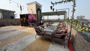 a patio with tables and chairs on a roof at Hotel Advika in Kaithal