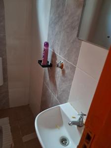 a bathroom with a sink and a pink candle on a shelf at Watene's Homes in Nairobi +15 photos