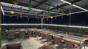 an empty room with chairs and tables and lights at Hotel Advika in Kaithal