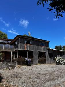 a barn with a bird on the top of it at Casona de Campo in Puerto Varas