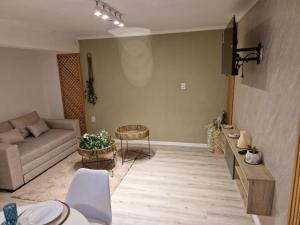 a living room with a couch and a table at Estudio Villa Rosas in Rafaela