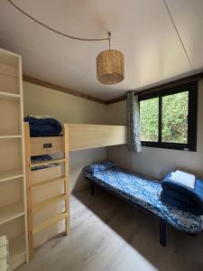 a room with two bunk beds and a window at Camping Deva in Deva +52 photos