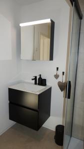 a bathroom with a sink and a mirror at Chalet Sofia in Bettmeralp +8 photos