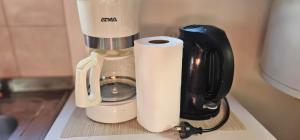a coffee maker with a roll of paper towels on a counter at Casa Pier Giorgio in El Chalten