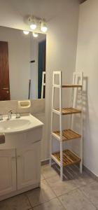 a bathroom with a sink and a ladder next to a mirror at Casa Pier Giorgio in El Chalten +22 photos