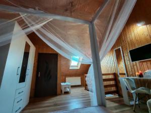a bedroom with a bed with a canopy at casa tip duplex in Zărneşti