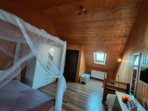 a bedroom with a bunk bed in a wooden house at casa tip duplex in Zărneşti