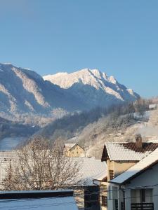 a view of a mountain with snow covered mountains at casa tip duplex in Zărneşti +5 photos