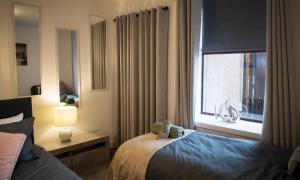 a hotel room with a bed and a window at Rook View in Buckie