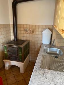 a kitchen with a sink and a stove at Samalmglück in Maria Luggau