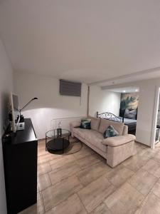 a living room with a couch and a table at Pendler Montagewohnung Kandern, Lörrach, Basel D,CH, FR in Holzen +12 photos