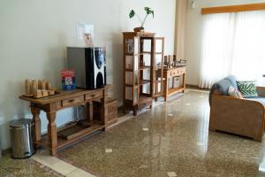 a living room with a couch and a table and a refrigerator at New Life Piracicaba by Atlantica in Piracicaba