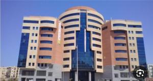 two tall buildings with windows in front of them at إقامة المول in Fort de lʼEau