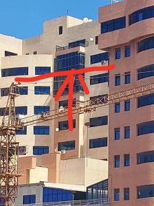 a building with a red x on the side of it at إقامة المول in Fort de lʼEau