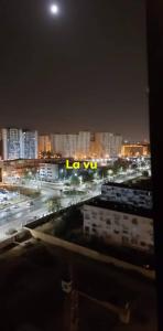 a view of a city at night with a lit up sign at إقامة المول in Fort de lʼEau +2 photos