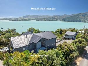 an aerial view of a house next to a body of water at Whangaroa Casa Roca House in Kaeo +4 photos