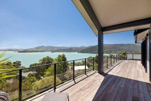 a balcony with a view of the water at Whangaroa Casa Roca House in Kaeo