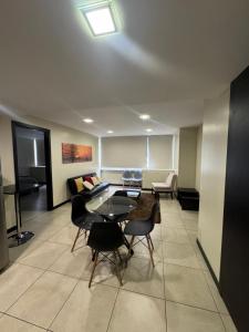 a living room with a table and chairs and a couch at Love Apartment in Guayaquil