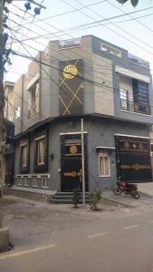 a building with a sign on the front of it at The 104-H in Faisalabad