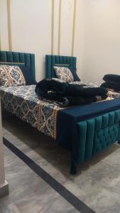 a bed with a cat laying on top of it at The 104-H in Faisalabad