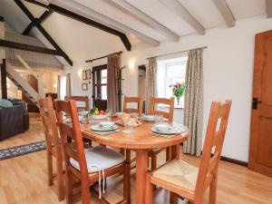 a dining room with a wooden table and chairs at Stable Cottage in Whitby