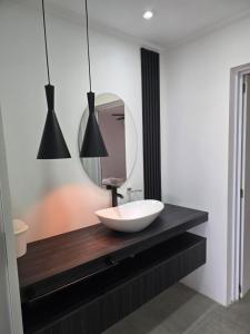 a bathroom with a white sink and a mirror at Lago Santa Ana in Santa Ana +16 photos