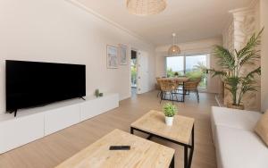 a living room with a flat screen tv on a wall at Mar Blau in Port d'Alcudia
